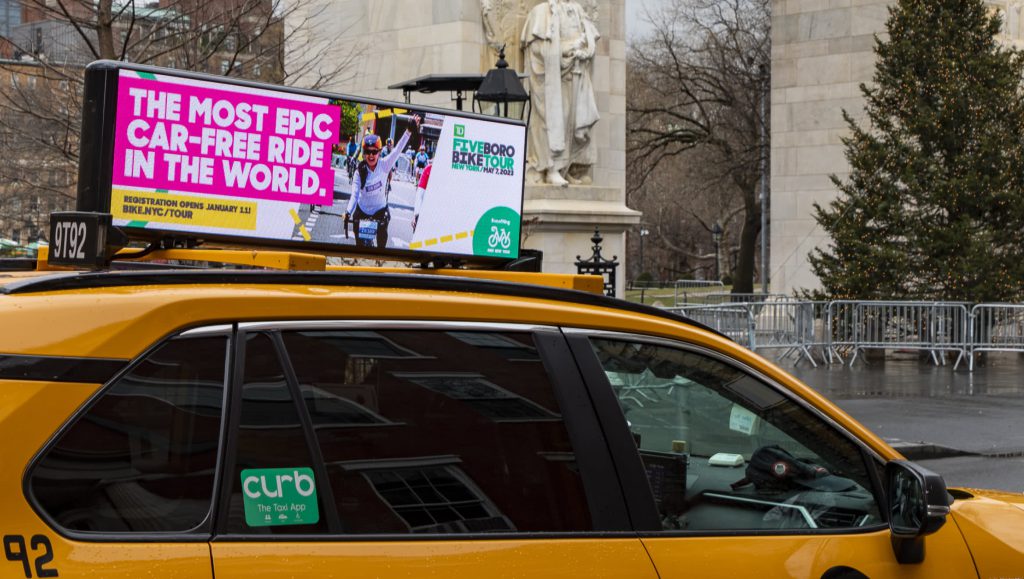Taxi Ad: The most epic car-free ride in the world. Registration opens January 11! BIKE.NYC/TOUR TD logo FIVE BORO BIKE TOUR NEW YORK/ MAY 7, 2023