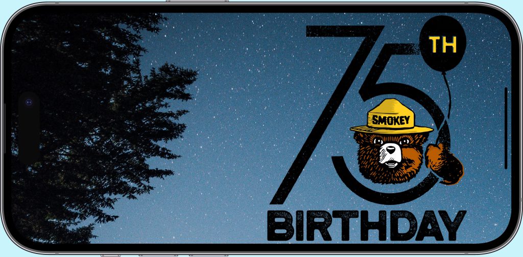 Smokey Bear 75th Birthday Campaign image on an iPhone screen. Smokey is holding a balloon and wearing his iconic hat.