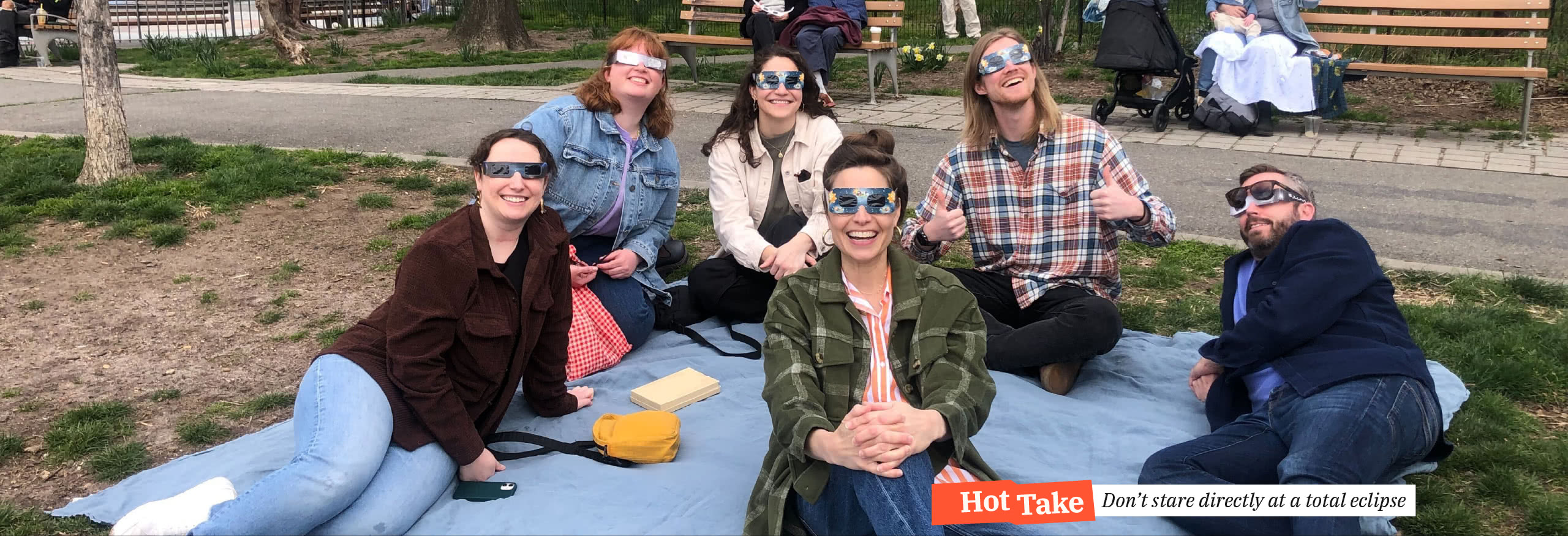 The HelpGood East Team wearing eclipse glasses, safely enjoying a total eclipse of the sun. Hot Take: Don't stare directly at a total eclipse.